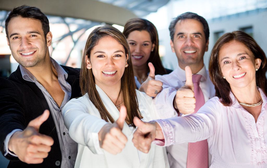 Happy business team with thumbs up and smiling